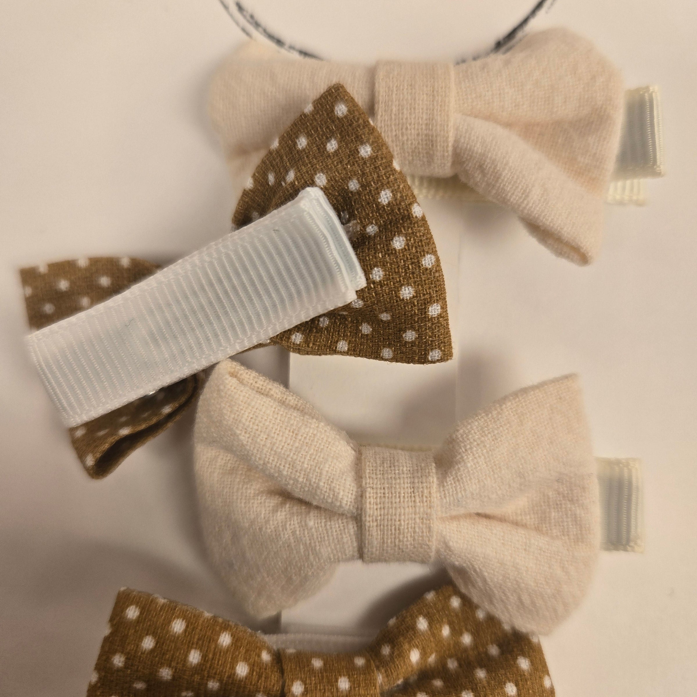 Set of four hair bows with polka dot patterns on a white background